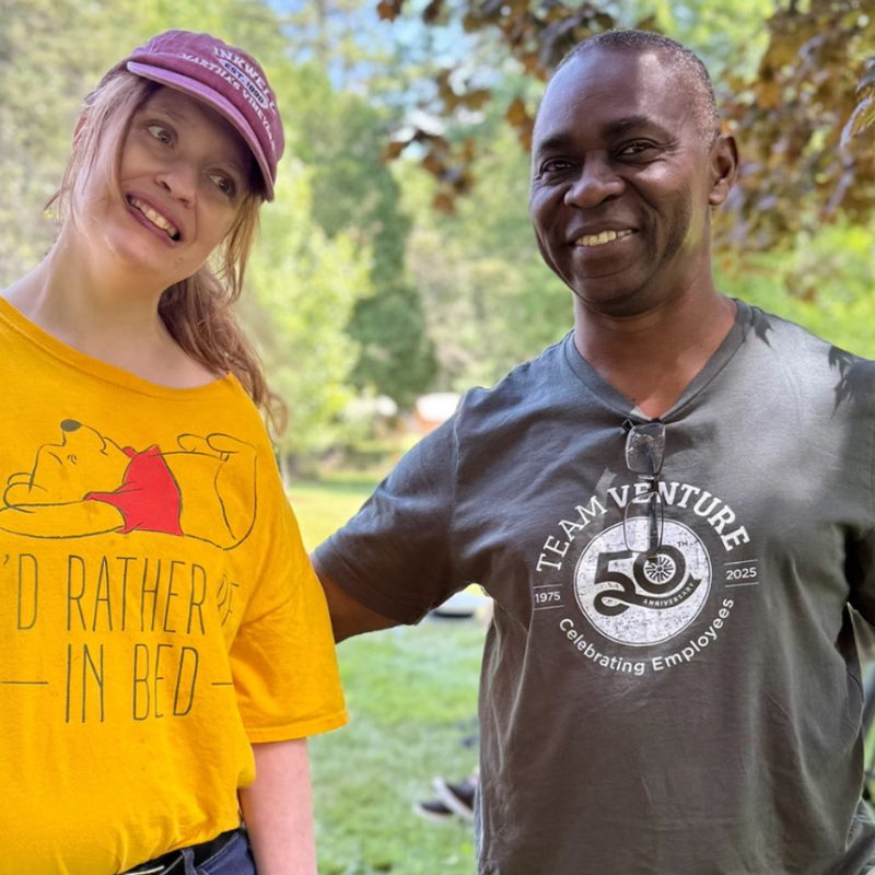 Two Venture employees smiling together outdoors
